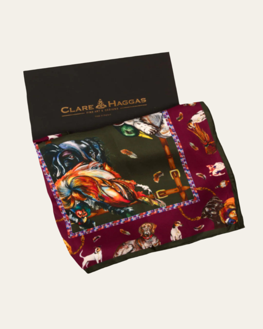 It’s A Dog’s Life silk scarf featuring detailed illustrations of gun dogs and game birds in hunter green and oxblood