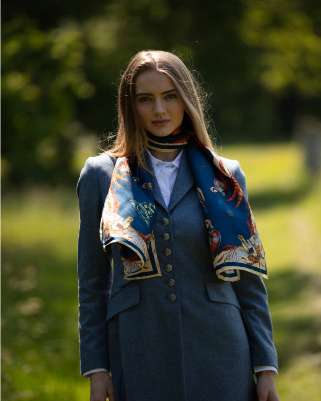 Luxury British-made silk scarf by Clare Haggas featuring hand-drawn game birds and a flowing border