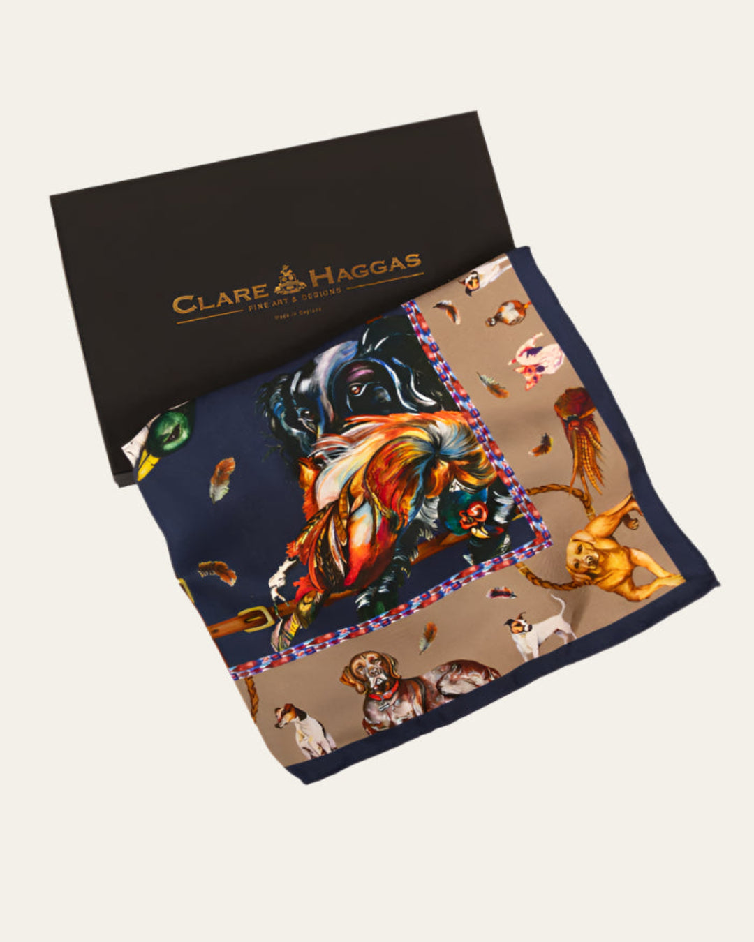 Luxury silk scarf by Clare Haggas showcasing gun dogs and game birds, classic square design in navy and fawn