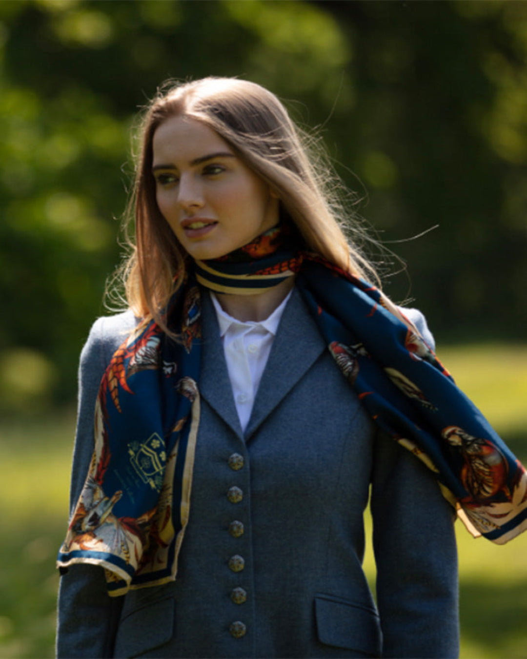 Petrol, navy, and gold silk scarf with intricate game bird illustrations and versatile styling options