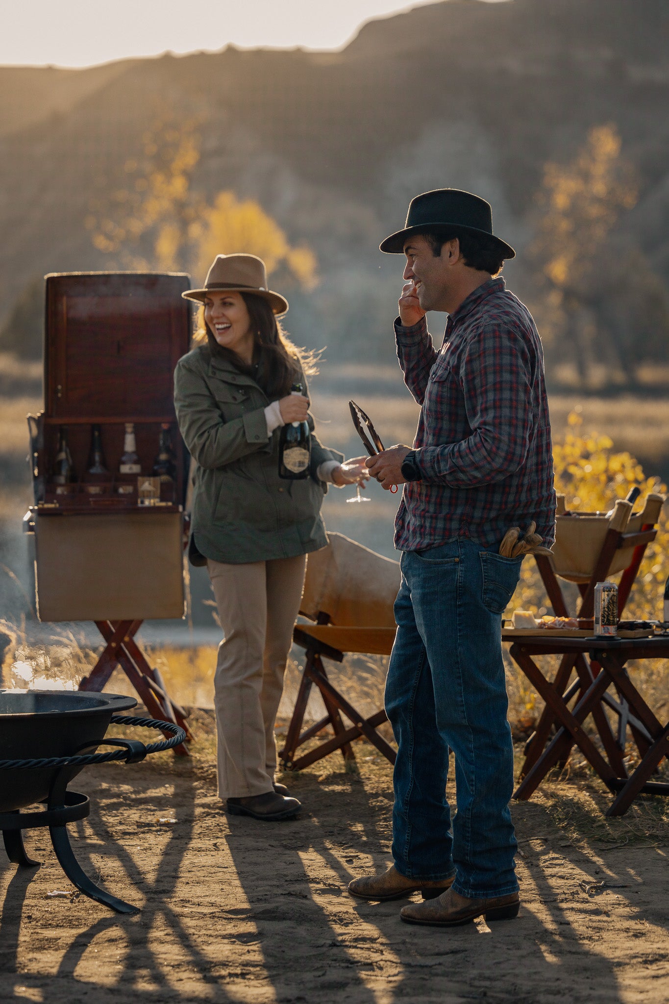 Safari field bar set up outdoors beside a fire, part of a safari furniture setting