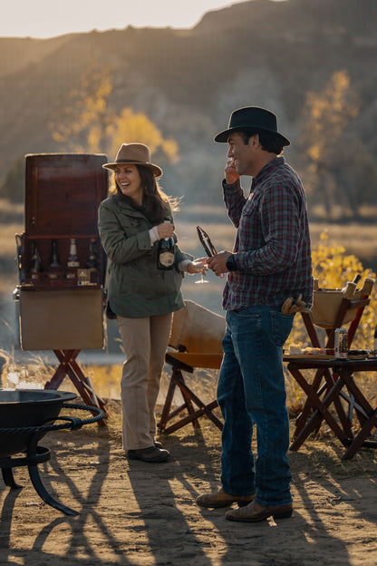 Safari field bar set up outdoors beside a fire, part of a safari furniture setting