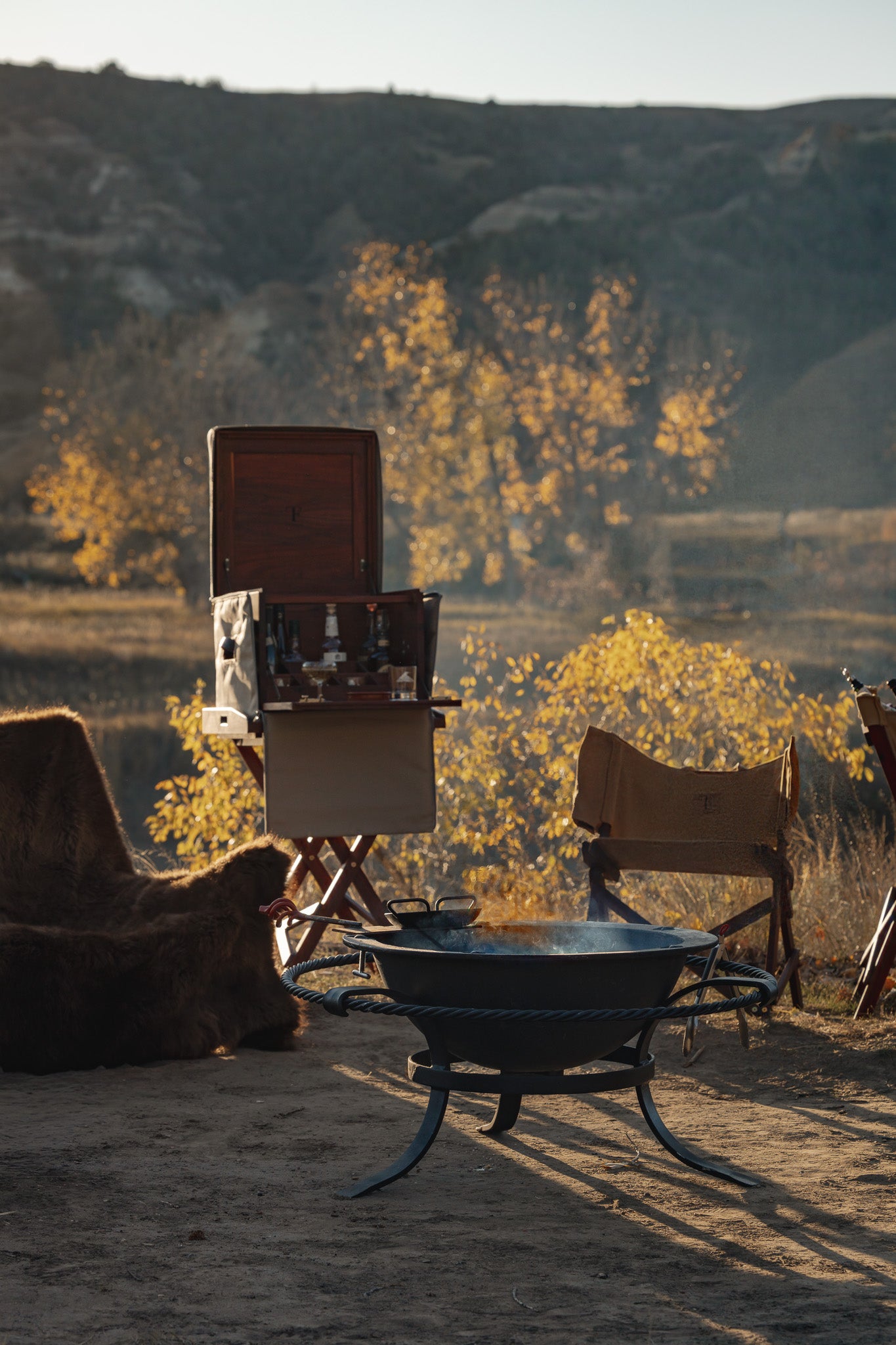 Safari field bar styled with campaign chairs and tray table in lodge setting